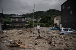 Japan rescuers go house to house as flood toll hits 141.jpg