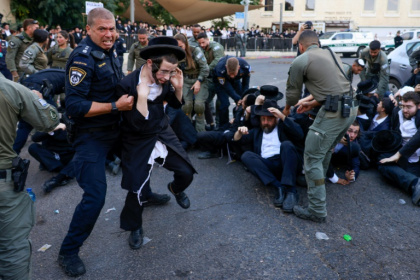 Israeli security personnel in Jerusalem disperse ultra-Orthodox Jewish protesters opposed to conscription, on October 31, 2024