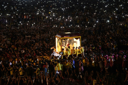 The black statue of Jesus of Nazarene leaves a park following a mass during an annual religious procession in Manila on Thursday