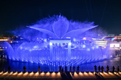 Visitors watch a water and light display during a media preview day for the 2025 Osaka Expo in Osaka on April 9, 2025