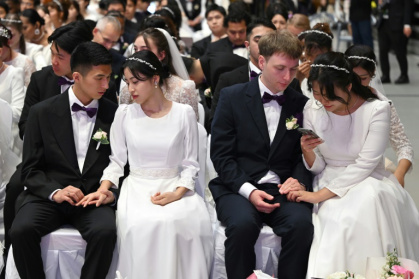 Couples attending a mass wedding ceremony organised by the Unification Church at Cheongshim Peace World Center in Gapyeong