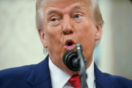 US President Donald Trump says using negotiating tactics to advance the interests of the United States is not the same as "chickening out" - Jim WATSON (AFP)