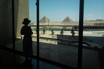 A visitor looks out towards the Giza pyramid complex as she tours the Grand Egyptian Museum in Giza on the southwestern outskirts of the capital Cairo on May 5, 2025 - Khaled DESOUKI (AFP)