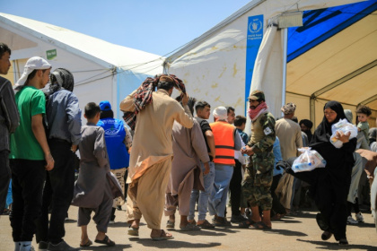 Newly arrived Afghan migrants from Iran queue  to receive food packages  at the Islam Qala border crossing in Herat. A massive spike in millions of migrants could fuel Islamic State militancy, diplomatic and security sources fear - Mohsen KARIMI (AFP)
