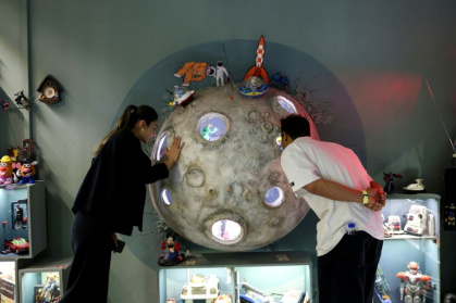 Visitors look at items displayed at a toy museum in the Iranian capital Tehran - - (AFP)