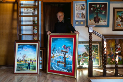 Painter Pavel Hajko poses with his work at his home studio northern Serbia - Andrej ISAKOVIC (AFP)