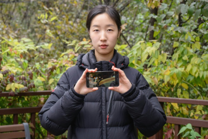 When Korean student Kim Da-in saw a military tank turning towards the National Assembly, she ran at it without hesitation - Anthony WALLACE (AFP)
