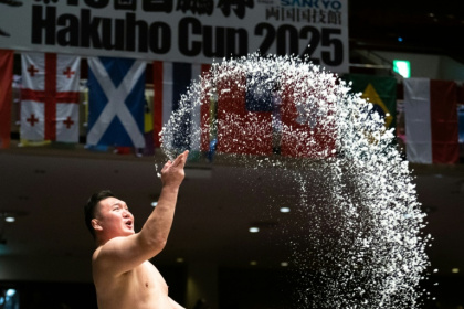 Sumo wrestlers throw salt on the dohyo to drive away evil spirits - Philip FONG (AFP)