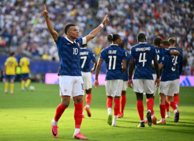 France's Kylian Mbappe celebrates his team's third goal in a 3-0 victory over Sweden - ANGELA WEISS (AFP)
