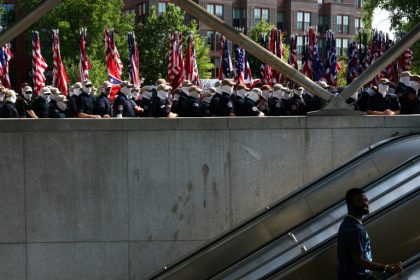 Masked men gather at a Washington metro stop on July Fourth, some of them carrying Confederate flags - Finn Gomez (AFP)