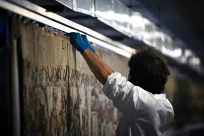 The tapestry is being transported under police protection - LOU BENOIST (AFP)